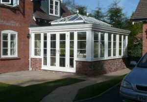 Elegant glass extension with floor-to-ceiling windows, complementing a traditional South Wales property.