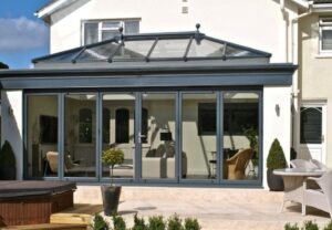 Contemporary glass extension maximizing natural light and blending seamlessly with a South Wales home.