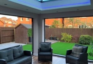 Stylish glass extension featuring sleek design and enhancing indoor-outdoor flow in a South Wales property.