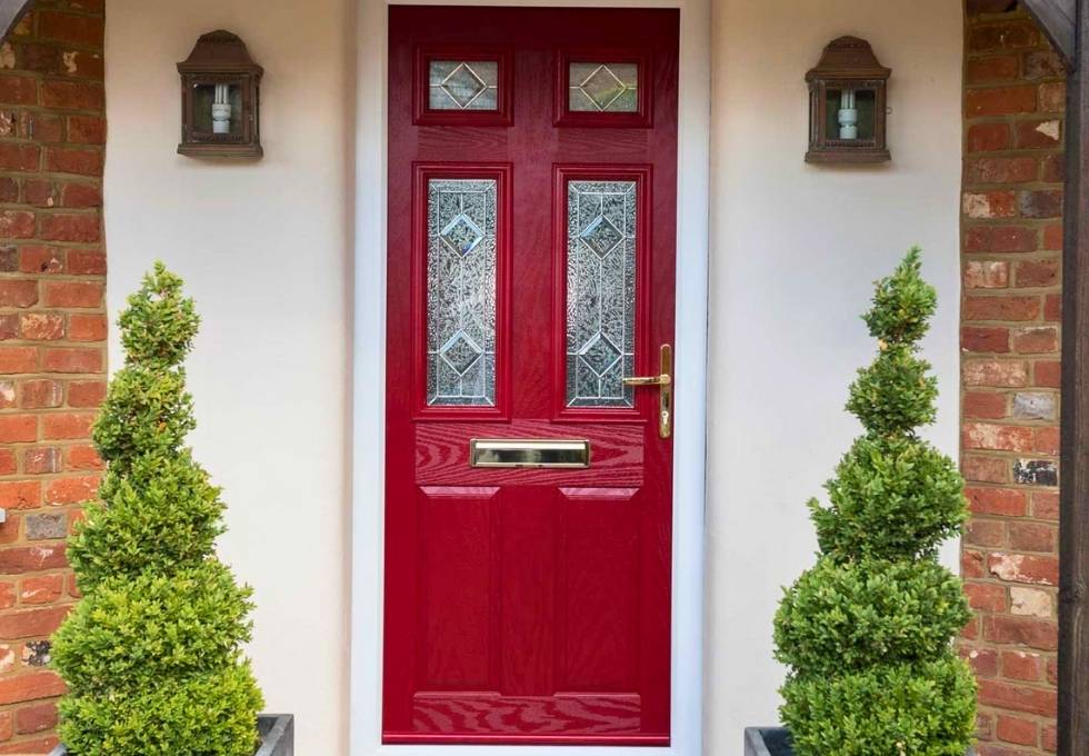 Traditional red composite door on a Newport home stylish options.